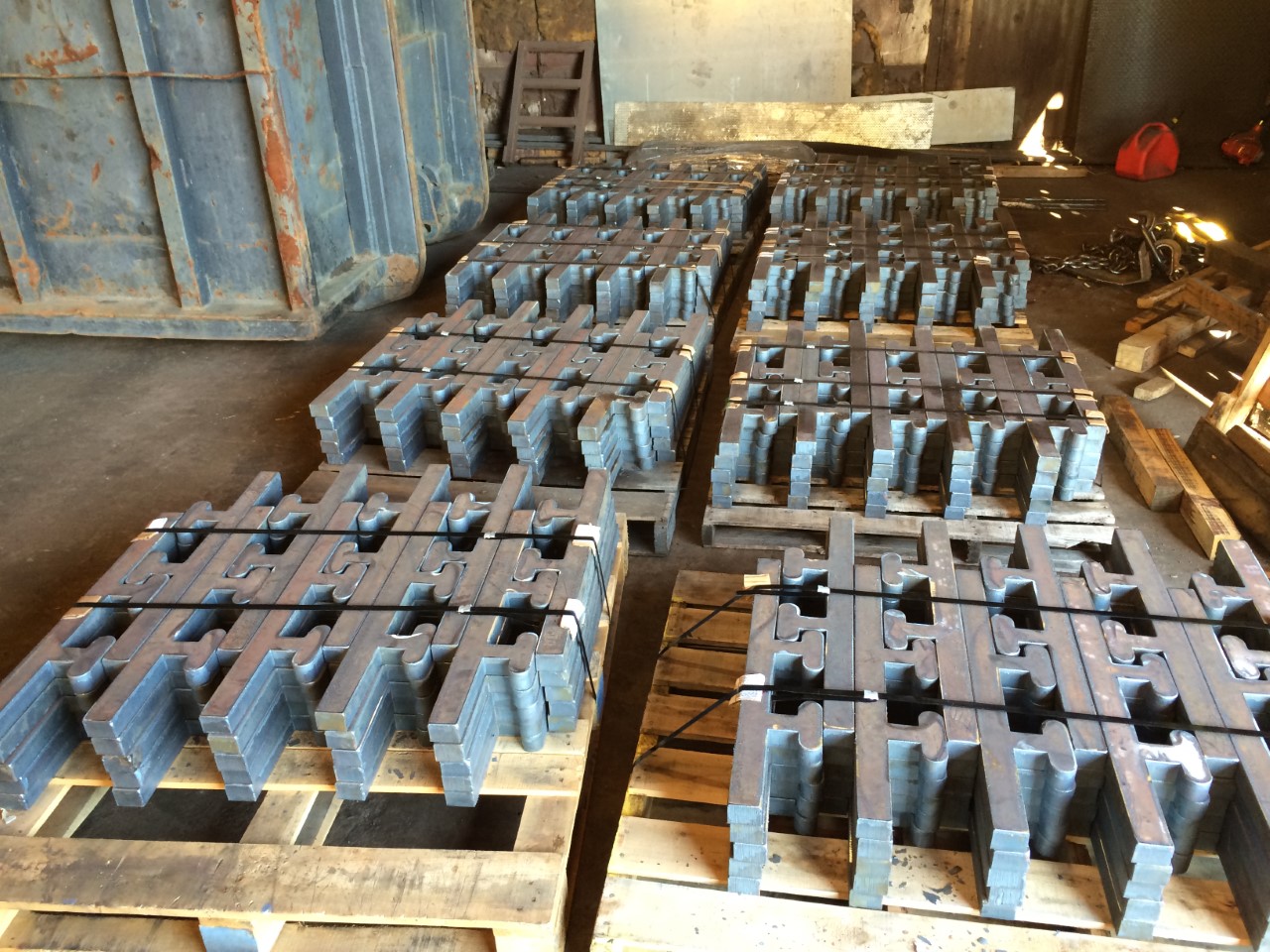 stacked cut metal blocks on 8 pallets